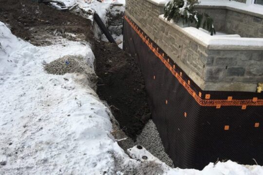 A hole is dug to do foundation repair.