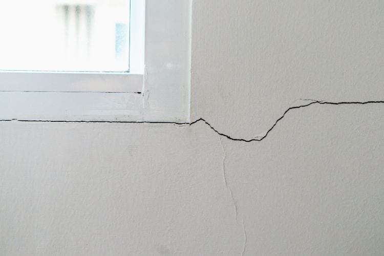 A crack forms in the basement by a window. It's a hairline crack that stretches by the window and underneath it.