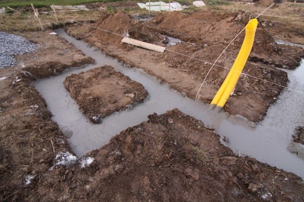 Water fills up the holes of what is meant to be a basement.