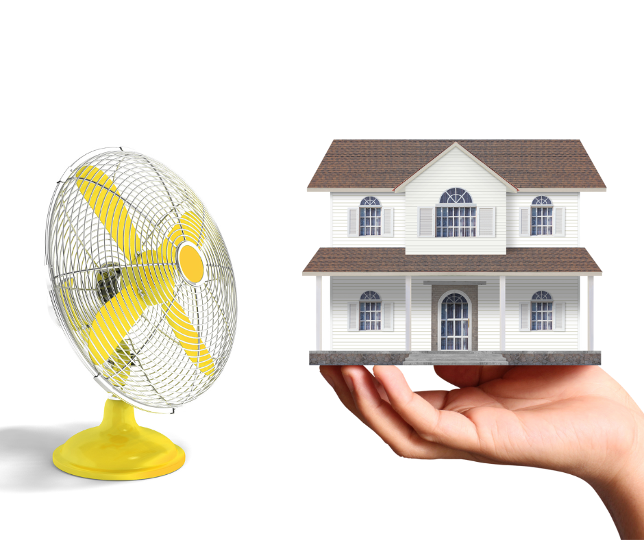 An image of a fan next to a house being held by a hand.