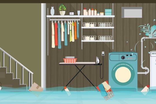 A basement laundry room is experiencing water problems as it is flooded. A bucket, box, and laundry basket are all floating in the flooded room.